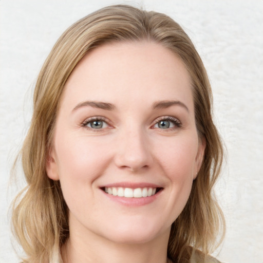 Joyful white young-adult female with medium  brown hair and blue eyes