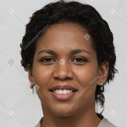 Joyful black young-adult female with short  black hair and brown eyes