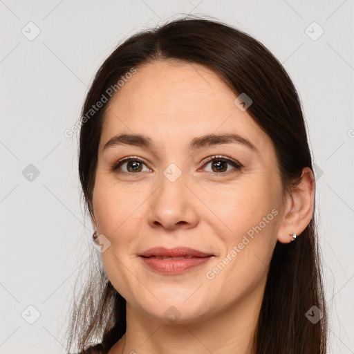 Joyful white young-adult female with long  brown hair and brown eyes