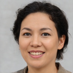 Joyful latino adult female with medium  brown hair and brown eyes