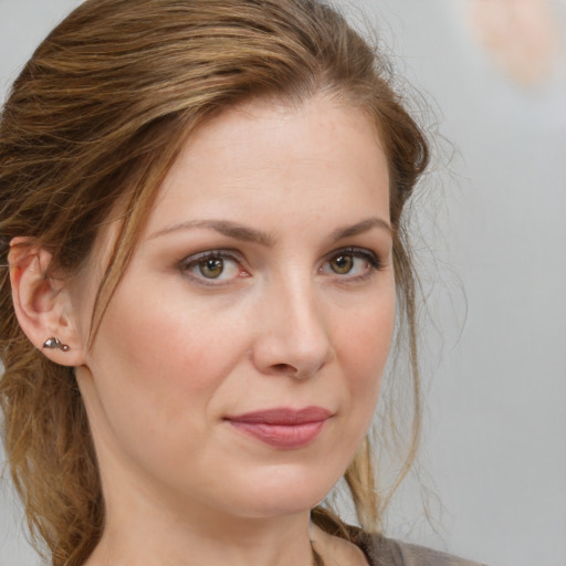 Joyful white adult female with medium  brown hair and grey eyes