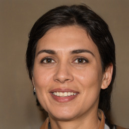 Joyful white adult female with medium  brown hair and brown eyes