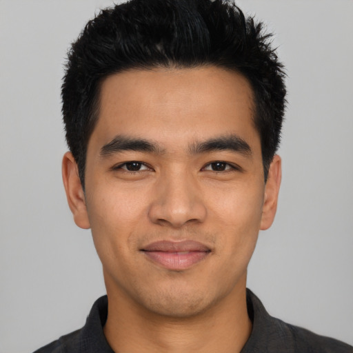 Joyful asian young-adult male with short  black hair and brown eyes