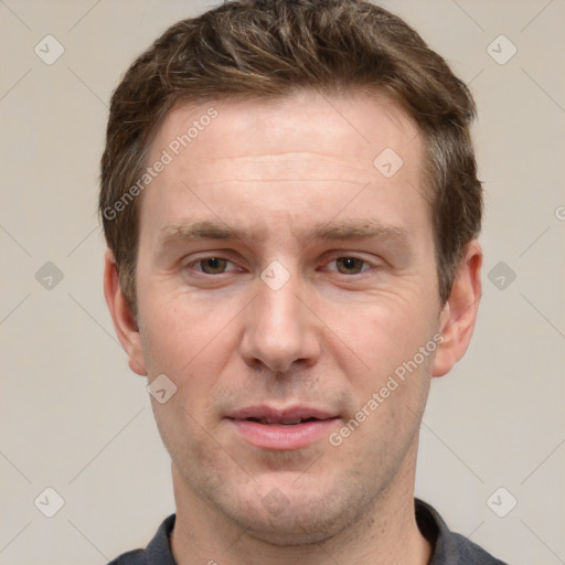 Joyful white adult male with short  brown hair and grey eyes