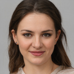 Joyful white young-adult female with medium  brown hair and grey eyes