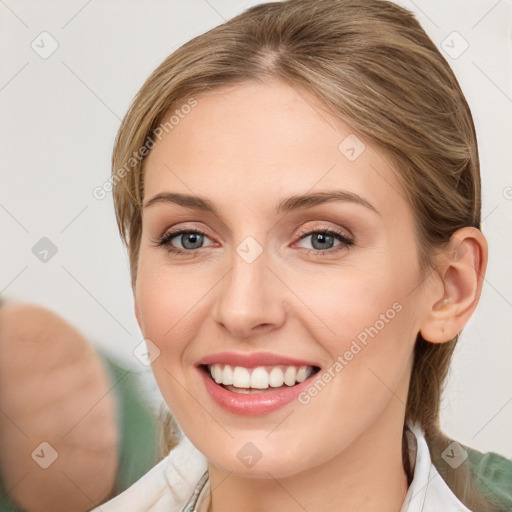 Joyful white young-adult female with medium  brown hair and green eyes