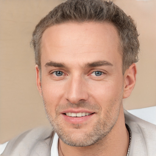 Joyful white adult male with short  brown hair and brown eyes