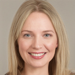 Joyful white young-adult female with long  brown hair and blue eyes