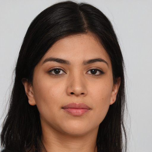 Joyful latino young-adult female with long  brown hair and brown eyes
