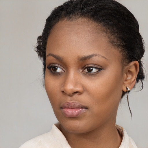 Neutral black young-adult female with medium  brown hair and brown eyes