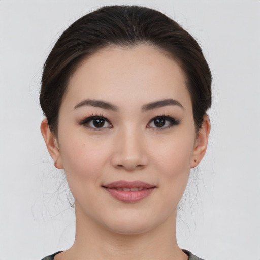 Joyful asian young-adult female with medium  brown hair and brown eyes