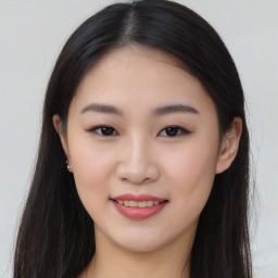 Joyful asian young-adult female with long  brown hair and brown eyes