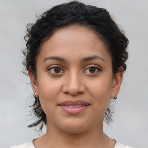 Joyful latino young-adult female with medium  brown hair and brown eyes