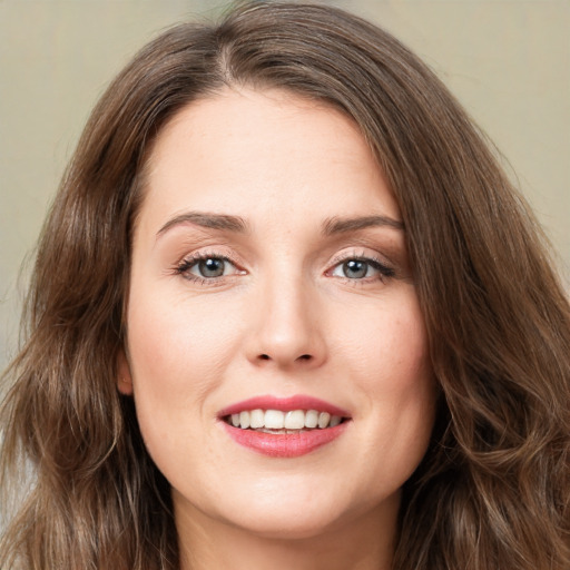 Joyful white young-adult female with long  brown hair and green eyes