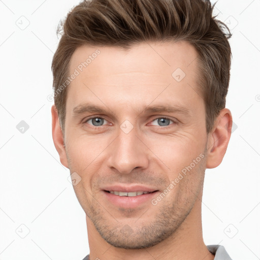 Joyful white young-adult male with short  brown hair and grey eyes