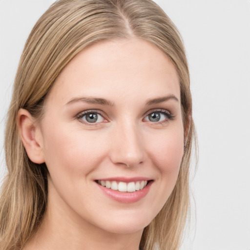 Joyful white young-adult female with long  brown hair and blue eyes