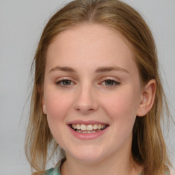 Joyful white young-adult female with long  brown hair and blue eyes