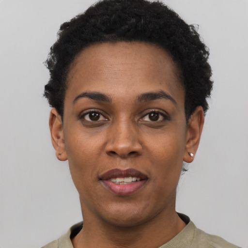 Joyful black young-adult female with short  black hair and brown eyes