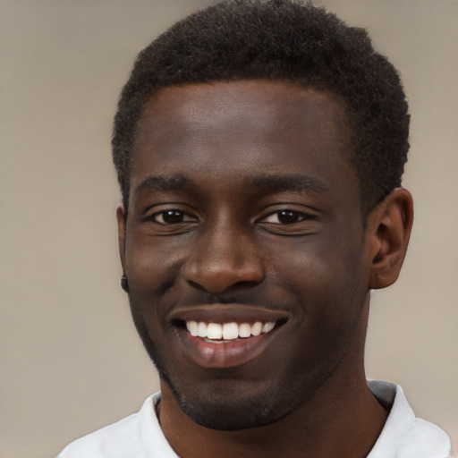 Joyful black young-adult male with short  brown hair and brown eyes