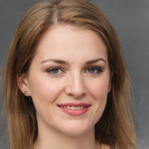 Joyful white young-adult female with long  brown hair and grey eyes