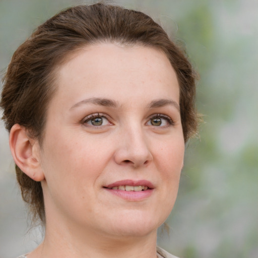 Joyful white young-adult female with medium  brown hair and green eyes