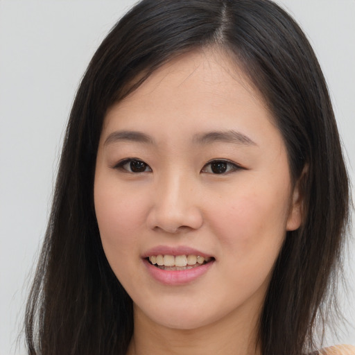 Joyful asian young-adult female with long  brown hair and brown eyes
