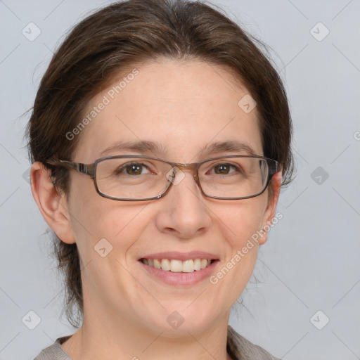 Joyful white adult female with medium  brown hair and blue eyes