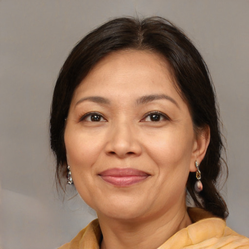 Joyful latino adult female with medium  brown hair and brown eyes