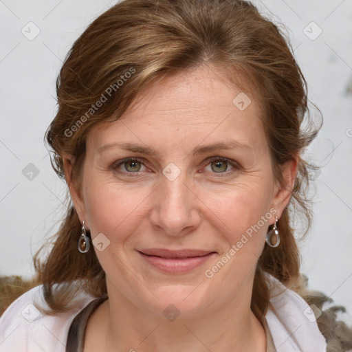 Joyful white adult female with medium  brown hair and blue eyes