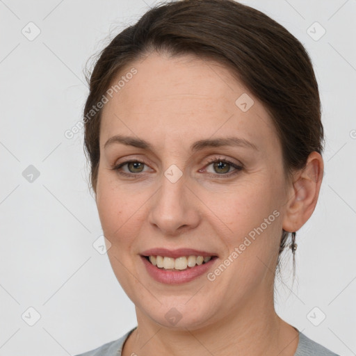 Joyful white adult female with medium  brown hair and grey eyes