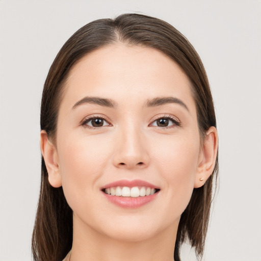 Joyful white young-adult female with long  brown hair and brown eyes