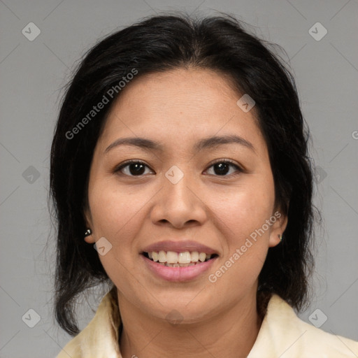 Joyful latino young-adult female with medium  brown hair and brown eyes