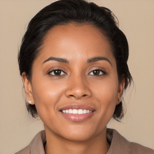 Joyful latino young-adult female with medium  black hair and brown eyes