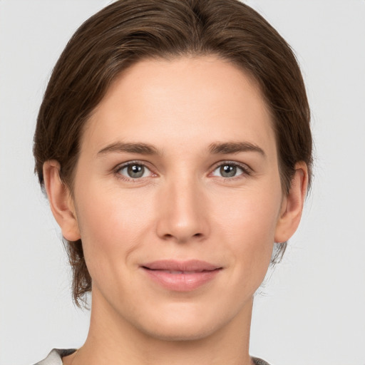 Joyful white young-adult female with medium  brown hair and grey eyes