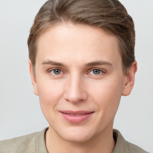 Joyful white young-adult female with short  brown hair and grey eyes