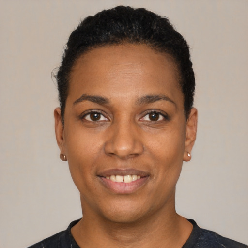 Joyful black young-adult female with short  black hair and brown eyes