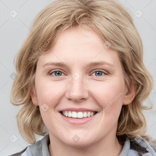 Joyful white young-adult female with medium  brown hair and blue eyes