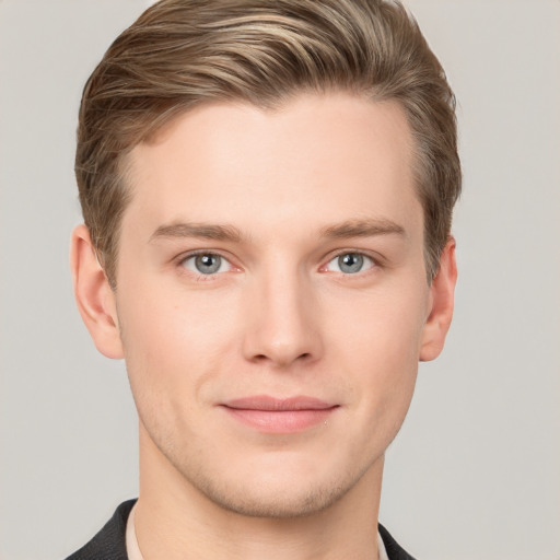 Joyful white young-adult male with short  brown hair and grey eyes