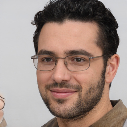 Joyful white adult male with short  black hair and brown eyes