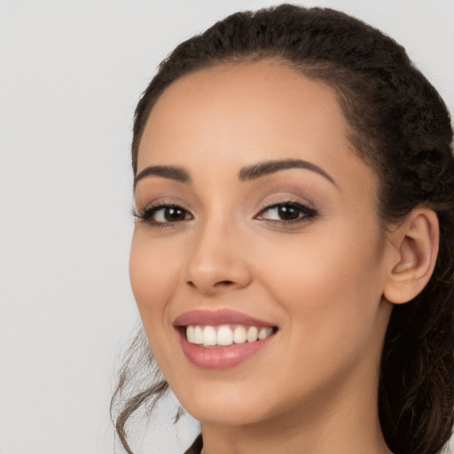 Joyful white young-adult female with long  black hair and brown eyes