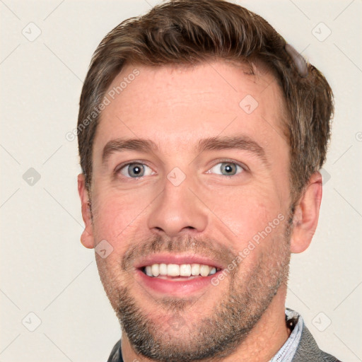 Joyful white adult male with short  brown hair and grey eyes