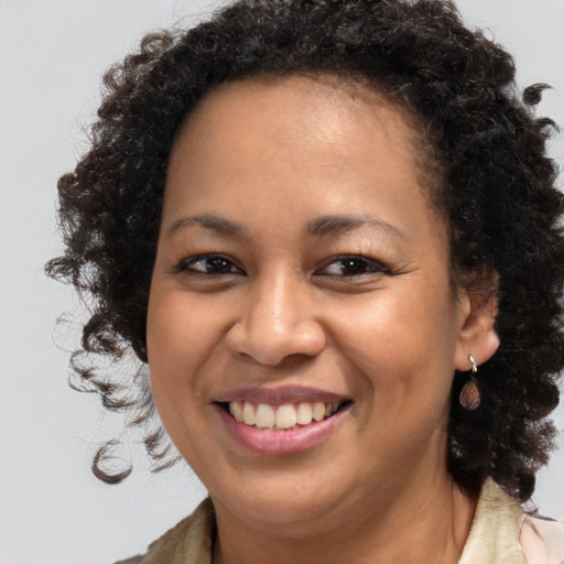 Joyful black young-adult female with medium  brown hair and brown eyes