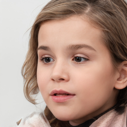 Joyful white child female with medium  brown hair and brown eyes