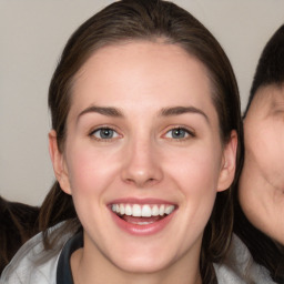 Joyful white young-adult female with medium  brown hair and blue eyes