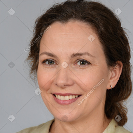 Joyful white adult female with medium  brown hair and brown eyes