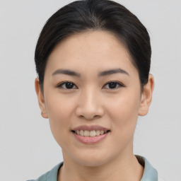 Joyful asian young-adult female with short  brown hair and brown eyes