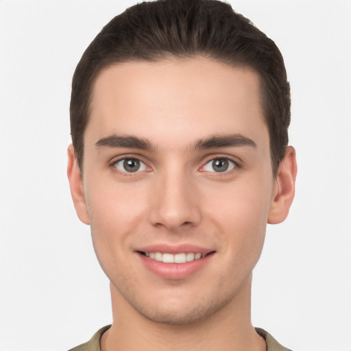 Joyful white young-adult male with short  brown hair and brown eyes