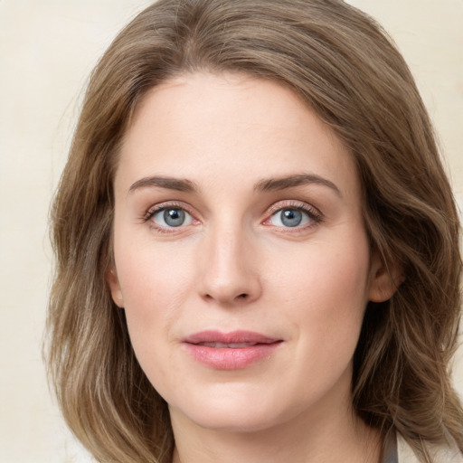 Joyful white young-adult female with medium  brown hair and green eyes