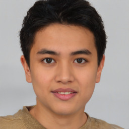 Joyful asian young-adult male with short  brown hair and brown eyes