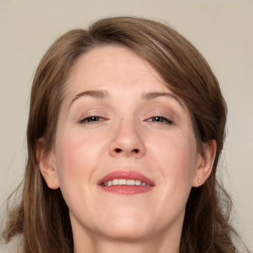 Joyful white adult female with medium  brown hair and grey eyes